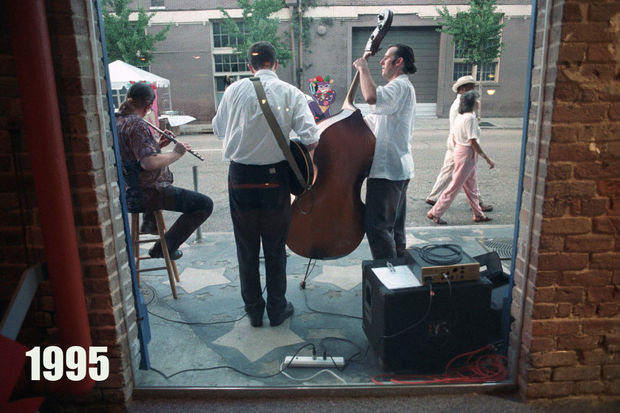 STAFF PHOTO BY TYRONE TURNER The Paul Henderson Trio plays on Julia St. Saturday, August 5, 1995 in the Warehouse Arts District of New Orleans as people enjoying the 'White Linen Night' art openings pass by. The trio's names are from left, Loren Pickford, Todd Duke, and Paul Henderson (bass). Besides the many art openings, there was music, food, and a beach art fashion show.