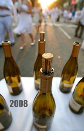DANNY BOURQUE / THE TIMES-PICAYUNE The 14th Annual White Linen Night takes place along Julia and Camp streets featuring art, drinks, and music on Saturday, August 2, 2008. A gathering of empty wine bottles decorates a table in the middle of Julia Street.