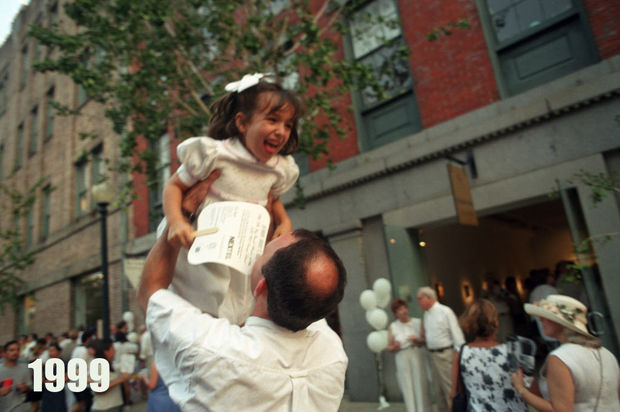 STAFF PHOTO BY JENNIFER ZDON Vittorio Colangelo tosses his friend's daughter Margaret Saux, 6, into the air outside of the Heriard-Cimino Gallery on Julia St. during White Linen Night Saturday, August 7, 1999 which is held throughout the Warehouse Arts District and included music, food and open several galleries.